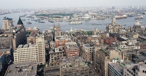 An aerial view of downtown Shanghai, China in the 1980s with the Huangpu River flowing through it.