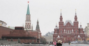 A view of the Red Square in Moscow, Russia on a cloudy day with many landmarks visible.