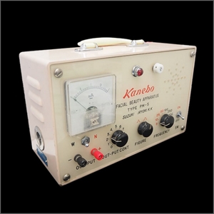 1967 analog device featuring many knobs and switches with the words “Kanebo” and “facial beauty apparatus” in the center.