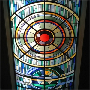 An Iconic, multi-colored stained glass roof window viewed from the ground perspective in Kanebo Cosmetics Education Center.