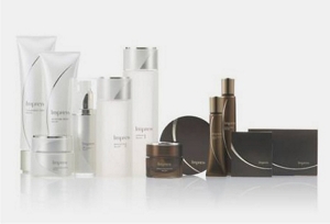 A wide variety of cosmetics bottles lined up with lighter color packaging on the left and darker color packaging on the right.