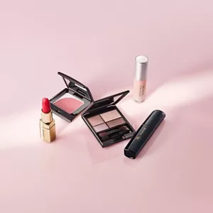 A range of make-up items from the Colours line on a pink background