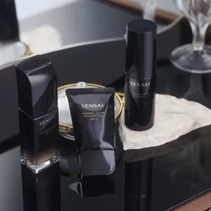 Three foundation products shawcased on black surface.