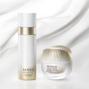 Absolute Silk Micro Mousse Treatment bottle and Total Form Expert Cream jar on a smooth, wavy white background