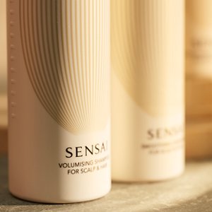 Focus on Volumising Shampoo; the other bottle is softly out of focus