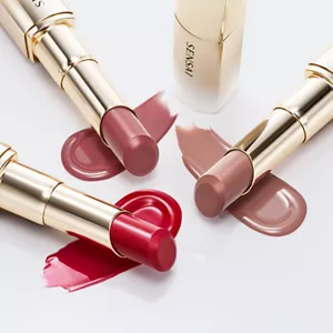 Three Moisture Intense Lipsticks laying down on each colour’s glossy strokes