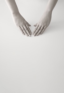 Two hands positioned palm down, prepared to start a skincare routine
