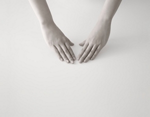 Two hands positioned palm down, prepared to start a skincare routine