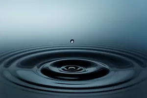 Close-up image of water with ripples and reflections.
