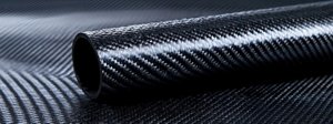 Close Up View Of A Carbon Fiber Tube With Intricate Weave Pattern And Shiny Surface Against A Dark Background