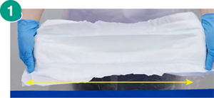 1.尿とりパッドの両端を持って軽く引っ張るように広げている画像。