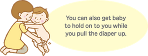 You can also get baby to hold on to you while you pull the diaper up.