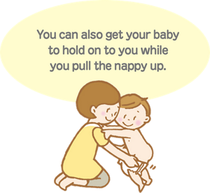 You can also get baby to hold on to you while you pull the diaper up.