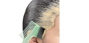 Applying cream on hairline.