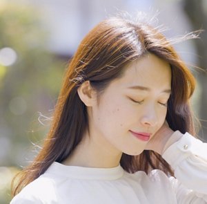 屋外で髪が風になびいている女性