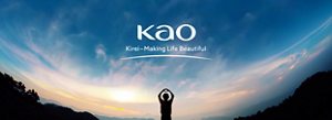 Silhouette of a person against a bright blue sky with wispy white clouds. Their arms are up and their hands are forming the shape of a heart. Kao's logo with the tagline Kirei-Making Life Beautiful is in the center.