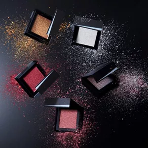 Photograph of five different-colored compacts made entirely of paper