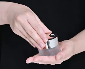 Photograph of a motion when handling a cosmetic container