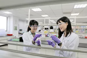 Two researchers checking the condition of experimental samples