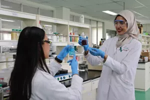 A researcher molding rubber gloves