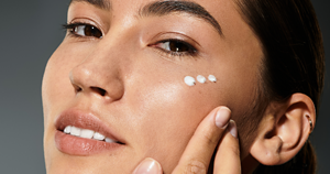 Woman gently patting eye creams around her delicate eye area