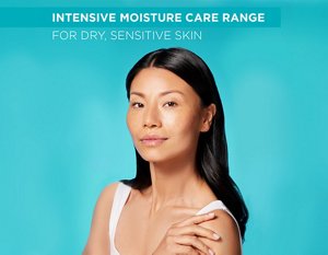 Woman with nourished skin against a teal background