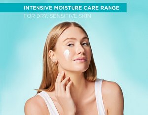 Young woman applying a small amount of Curél moisturiser to her cheek
