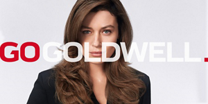 Woman with rose hair in front of bright background and Go Goldwell logo in front