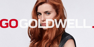Woman with brown hair in front of bright background and Go Goldwell logo in front