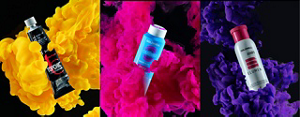 Goldwell topchic, colorance and elumen products floating in plumes of bright color