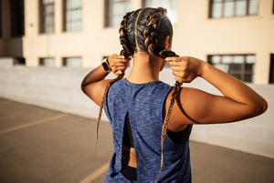 Woman with french plaits working out