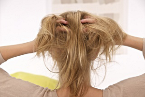 Blonde woman lifting up her hair
