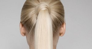 Portrait Of A Beautiful Young Blond Woman With Ponytail Hairstуle. Back view