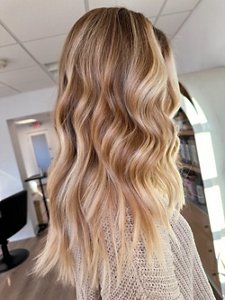 Woman with long dirty blonde hair with balayage