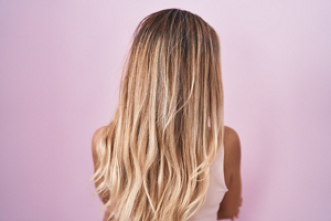 Woman with long balayaged dirty blonde hair with subtle babylights