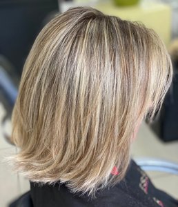 Mid-length dirty blonde hair with a root smudge