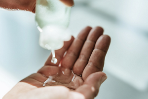 Woman pouring clear shampoo into her hand