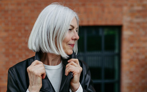 Glamorous older woman with her natural grey hair in a blunt bob