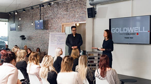 Many hair stylists at an educational training