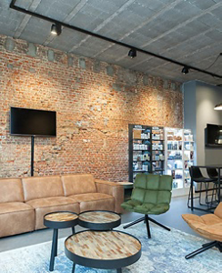 Cozy waiting area with sofa and armchair at hair salon