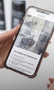 Kao Pro Shop open on a smartphone, held in the hand of a stylist