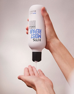 MOISTREPAIR shampoo being poured onto an open hand