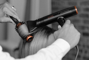 Hair being styled with hair dryer and VARIS Boar Brush