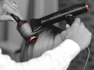 Hair being dried by stylist using VARIS products