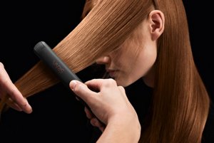Woman’s red hair being smoothed using VARIS 26mm smoother