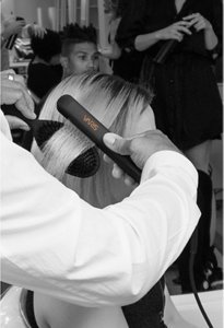 Male hair stylist smoothing woman's hair using VARIS 26mm smoother