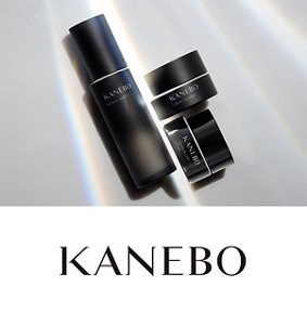 Four different Kanebo products featuring darker packaging surrounded by cream in the background and bubbles in the foreground. 