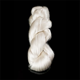 Many white, woven silk threads braided together against a black background. 