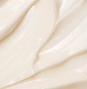 Nahaufnahme einer elfenbeinfarbenen Cremetextur.