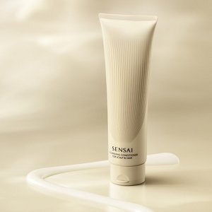 Nourishing Conditioner tube surrounded by a ribbon of cream texture